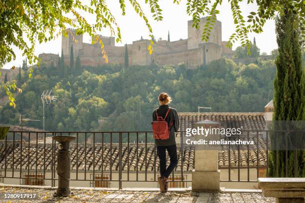 rear view of a woman looking at the alhambra, granada, andalusia, spain - alhambra spanien bildbanksfoton och bilder