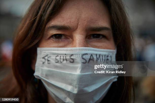 Protestor wears a mask with the slogan 'Je Suis Samuel' written on it during an anti-terrorism vigil at Place de La Republique for the murdered...