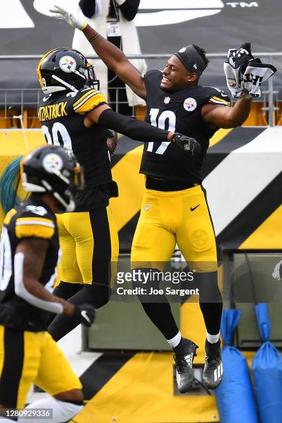 Minkah Fitzpatrick of the Pittsburgh Steelers celebrates with JuJu Smith-Schuster after his interception for a touchdown of Baker Mayfield of the...
