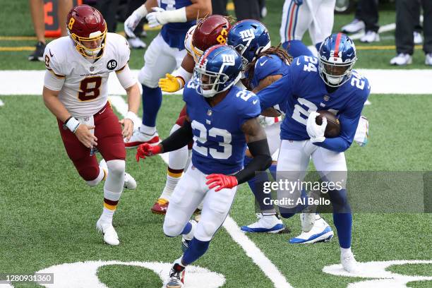 James Bradberry of the New York Giants runs after intercepting Kyle Allen of the Washington Football Team in the first quarter of their NFL game at...