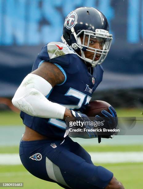 Running back Derrick Henry of the Tennessee Titans runs with the ball in the first quarter against the Houston Texans at Nissan Stadium on October...