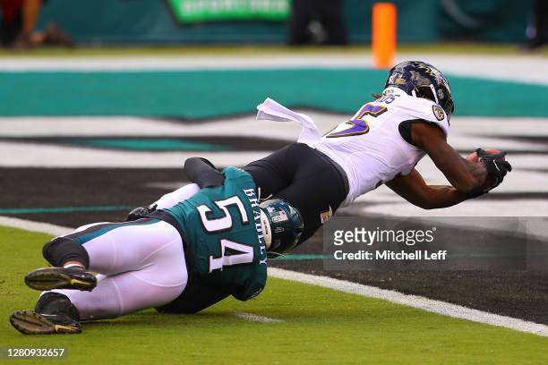 Gus Edwards of the Baltimore Ravens scores a touchdown against Shaun Bradley of the Philadelphia Eagles during the first quarter at Lincoln Financial...
