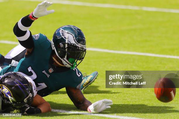 Willie Snead of the Baltimore Ravens fumbles out of bounds as Jalen Mills of the Philadelphia Eagles reaches for the ball during the first half at...