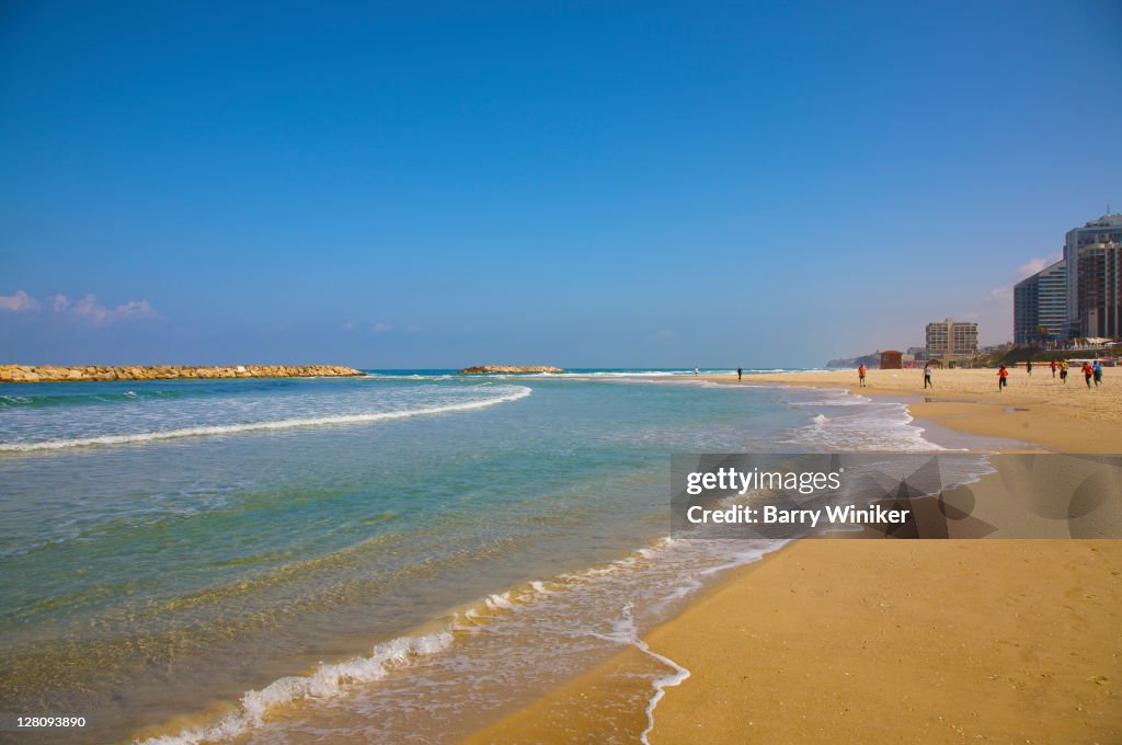 Sand beach, sky and hotel towers of Herzliya, Israel
