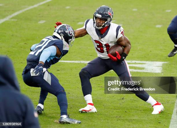 Running back David Johnson of the Houston Texans runs with the ball against Malcolm Butler of the Tennessee Titans in the second quarter at Nissan...