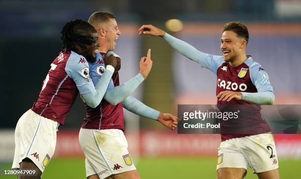 Ross Barkley of Aston Villa celebrates with teammates Bertrand Traore and Matty Cash after scoring his team's first goal during the Premier League...