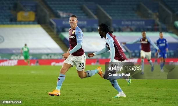 Ross Barkley of Aston Villa celebrates with teammate Bertrand Traore after scoring his team's first goal during the Premier League match between...