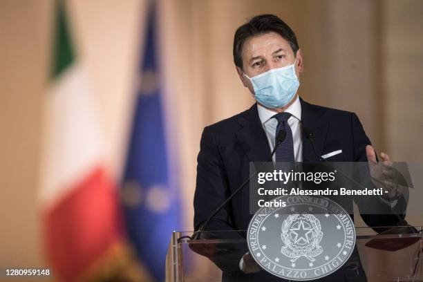 Italy's Prime Minister Giuseppe Conte announces new safety measures following a national surge of COVID-19 infections during a press conference at...