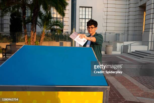 young woman mailing her ballot at the official pasadean ballot drop box - voting by mail stock pictures, royalty-free photos & images