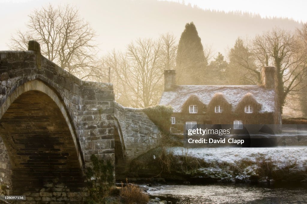 The famous cottage standing at Llanrwst Bridge that spans the Afon Conwy river, Llanrwst, North Wales, Britain, UK
