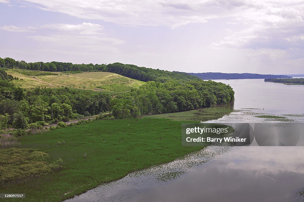 Aerial view of Hudson River showing trees and natural growth on land in middle of River, near Hudson, Columbia County, and Catskill, Greene County, New York