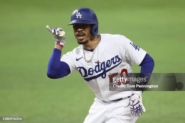 Mookie Betts of the Los Angeles Dodgers celebrates after hitting a single against the Atlanta Braves during the first inning in Game Seven of the...