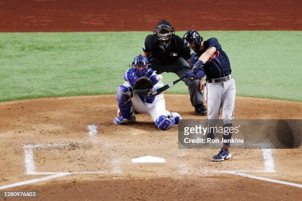 Dansby Swanson of the Atlanta Braves hits a solo home run against the Los Angeles Dodgers during the second inning in Game Seven of the National...
