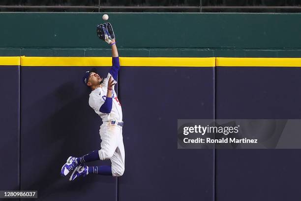 Mookie Betts of the Los Angeles Dodgers catches a fly ball at the wall on a hit by Freddie Freeman of the Atlanta Braves during the fifth inning in...