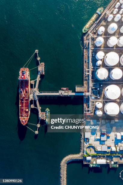 oil terminal is industrial facility for storage of oil and gas petrochemical products ready for transport to further storage facilities - oil tanker imagens e fotografias de stock