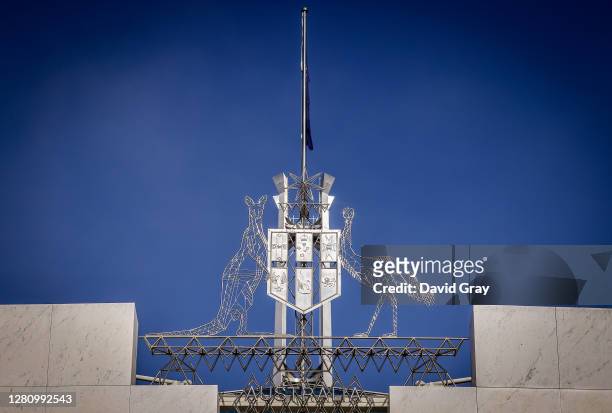 The Australian Coat of Arms stand at the front of Parliament House on July 9, 2020 in Canberra, Australia.
