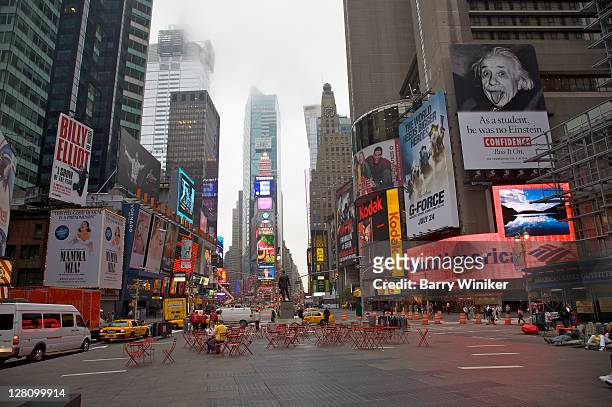 illuminated signs and seating in center of times square in early morning, new york, ny - times square manhattan stock pictures, royalty-free photos & images
