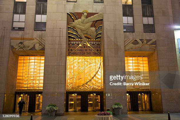 30 rockefeller plaza exterior with mural above entrance, lee lawrie's 'wisdom, light and sound' at night, new york, ny - 30 rockefeller plaza stock pictures, royalty-free photos & images