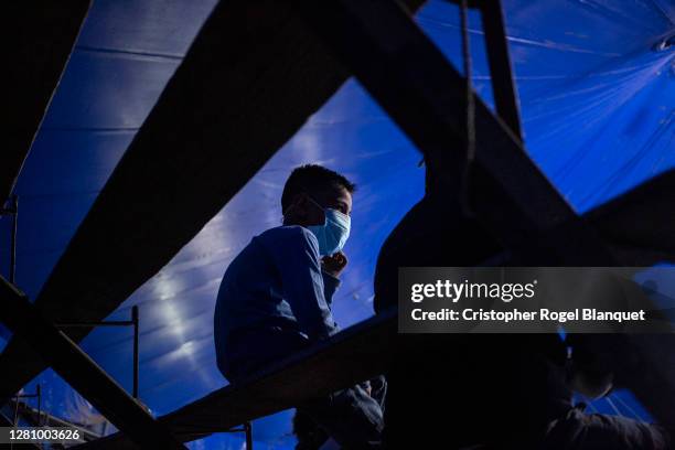 Child wears a mask at the Cedeño Brothers Circus on October 18, 2020 in Chimalhuacan, Mexico. Only 50 people attended the event, as the venue has a...