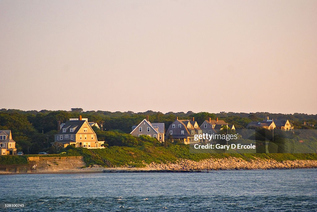 Various waterfront homes at sunset along coast in Woods Hole, Cape Cod, MA
