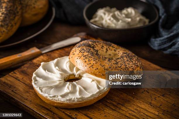 poppy seeds bagel spread with cheese crams - poppy seed stock pictures, royalty-free photos & images