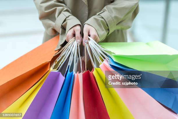 girl buying clothes - kaufsucht stock-fotos und bilder