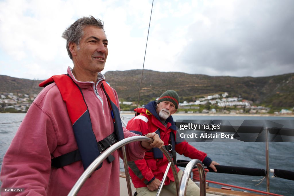 Two men sailing a yacht