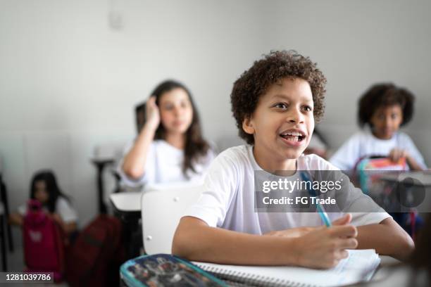 schoolboy studying in the classroom at school - schoolboy stock pictures, royalty-free photos & images