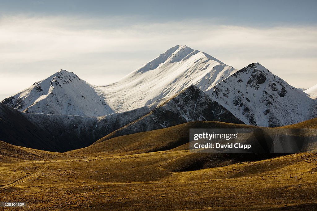 Moorland and snow capped mountains at Lindis Pass, South Island, New Zealand