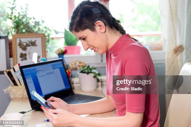 happy woman shopping online with laptop, smart phone and credit card - assistive technology student stock pictures, royalty-free photos & images