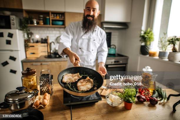 passionate young man cooking - cooking show stock pictures, royalty-free photos & images