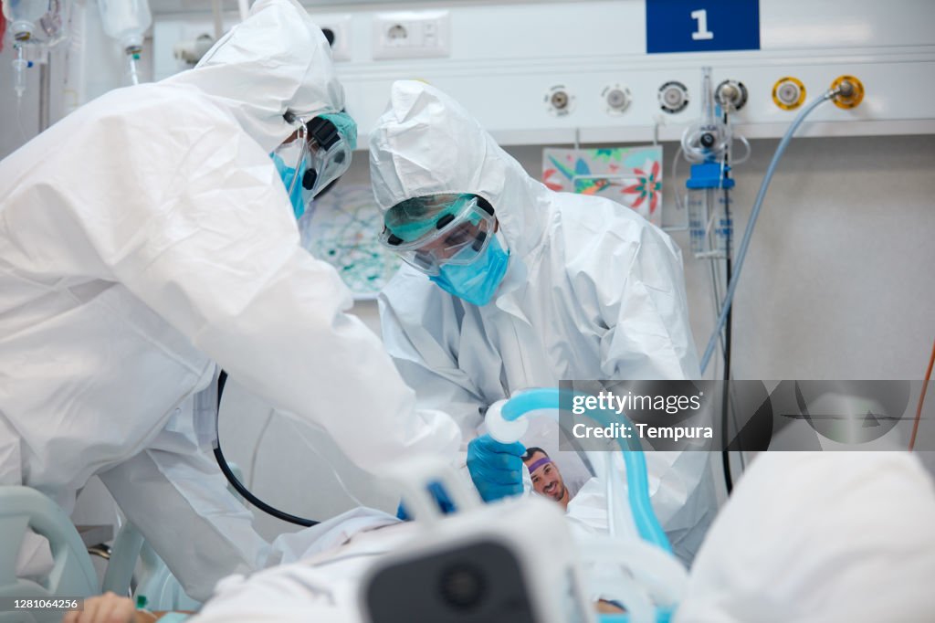 Gezondheidswerkers die een COVID-patiënt binnendonderen