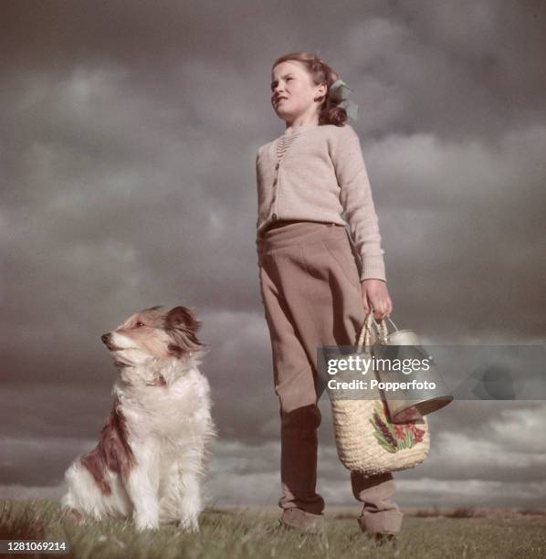 Nine year old Judith Chapman, a farmer's daughter from Comberton near Cambridge, posed with her dog 'Fiddy' on the family farm in Cambridgeshire,...