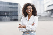 Young business woman wih crossed arms outdoor portrait
