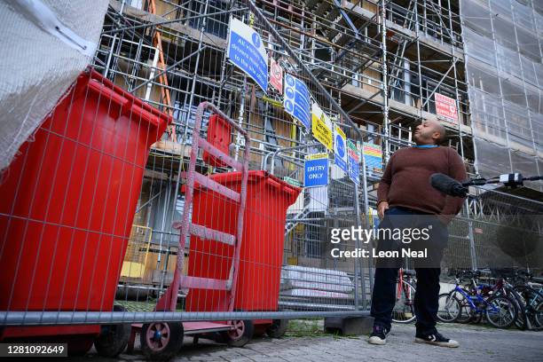 Man looks towards his property, which is among those listed unsafe, on October 19, 2020 in Brentford, England. Paragon is a development of six...