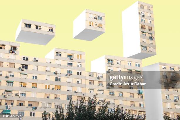 creative picture of urban blocks stacking like video game in surreal image manipulation. - woning huren stockfoto's en -beelden