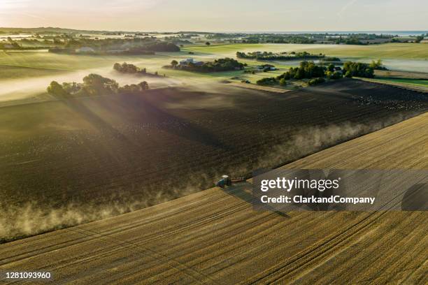 farmer plowing a field. - aerial view farm stock pictures, royalty-free photos & images