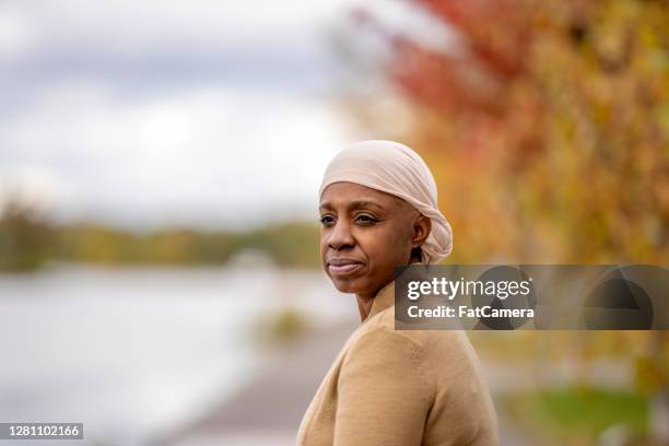 african american woman with cancer enjoying time outside - head tie stock pictures, royalty-free photos & images