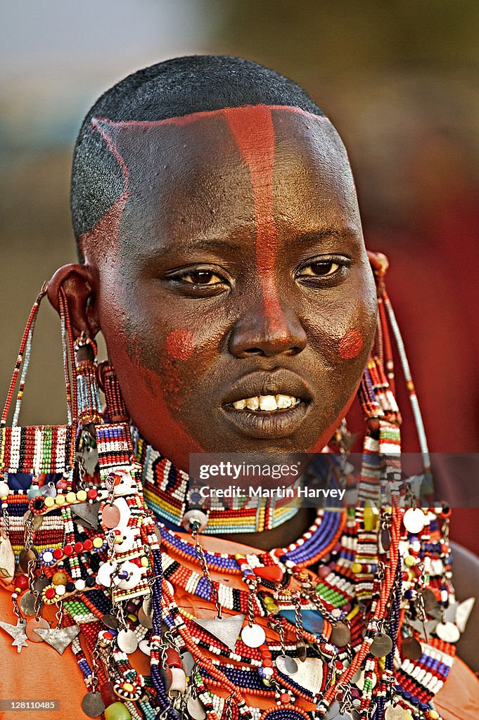 Maasai people. Popular necklaces worn by Maasai women, large flat disc that surrounds neck, made up of rows of beads threaded onto wire, secured and spaced with cow hide strips. Portrait of Nchumari. Near Amboseli NP, Kenya