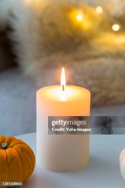 interior decor celebrating autumn with candle - white candle stock pictures, royalty-free photos & images