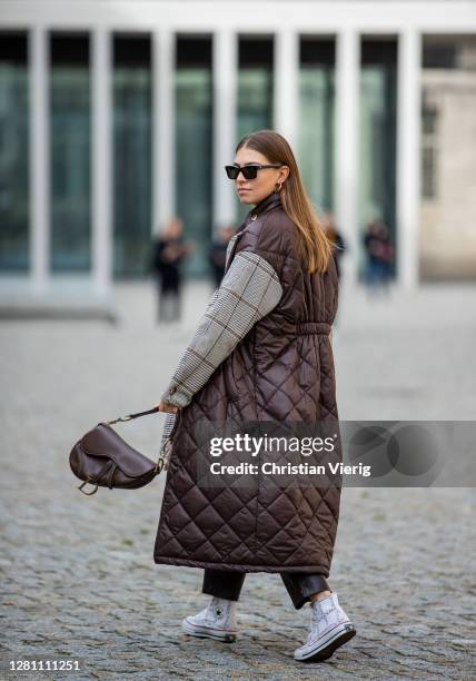 Swantje Soemmer is seen wearing brown coat with grey checkered sleeves Baum & Pferdgarten, black leather pants Zara, brown bag Dior, sunglasses...