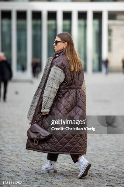Swantje Soemmer is seen wearing brown coat with grey checkered sleeves Baum & Pferdgarten, black leather pants Zara, brown bag Dior, sunglasses...