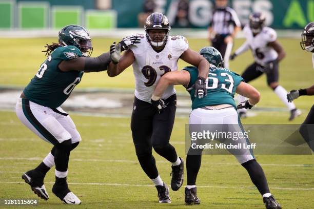 Jamon Brown and Jack Driscoll of the Philadelphia Eagles attempt to block Calais Campbell of the Baltimore Ravens at Lincoln Financial Field on...