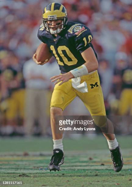 Tom Brady Quarterback for the University of Michigan Wolverines runs the ball downfield during the NCAA Florida Citrus Bowl college football game...