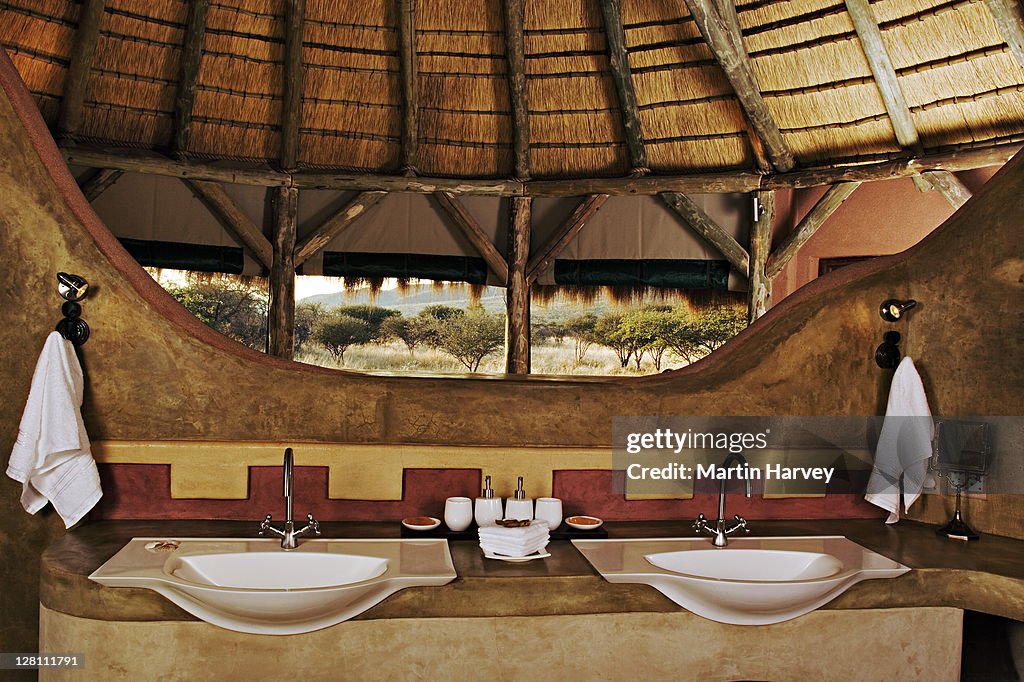 Bathroom of an African hut at the Bush Suite in Okonjima Private Game Reserve, Namibia. These lovely thatched huts offer guests the ultimate feeling of safari living. (PR: Property Released)