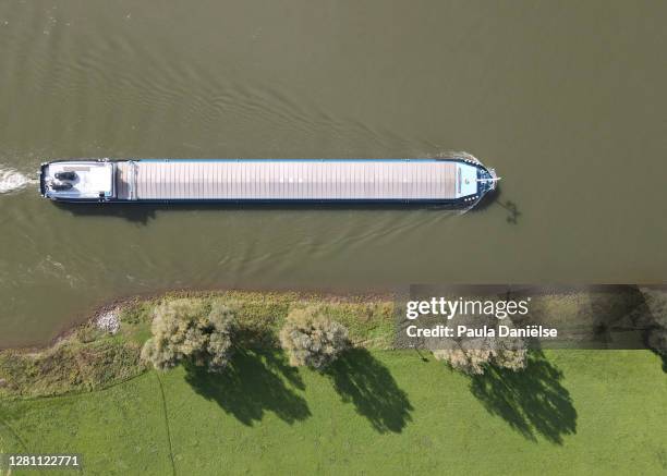 abstract aerial shot of a cargo boat on a river - gelderland stock pictures, royalty-free photos & images