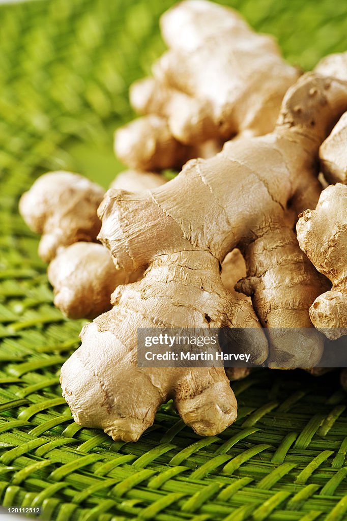 Pile of ginger root on green placemat.