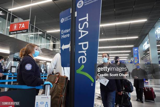 Passengers enter a Transportation Security Administration checkpoint at O'Hare International Airport on October 19, 2020 in Chicago, Illinois....