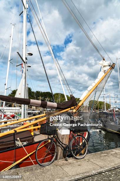 bicycle next to a traditional dutch flat bottomed ship - ijsselmeer stock pictures, royalty-free photos & images