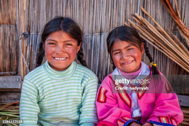 happy children on uros floating island, lake tititcaca, peru - peruvian culture stock pictures, royalty-free photos & images